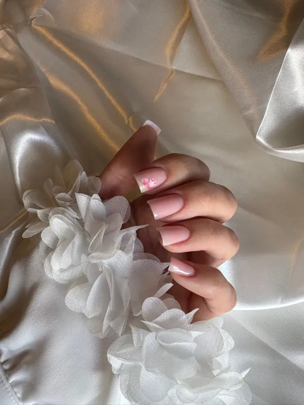 Soft pink French nails with floral accent — nail extensions Utrecht